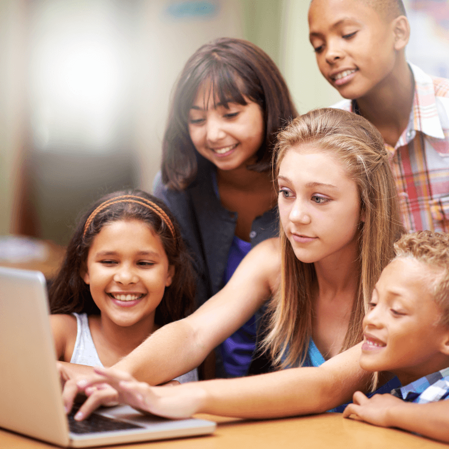 A group of students engaging in an online tutoring session around a laptop, highlighting the use of technology for educational collaboration.