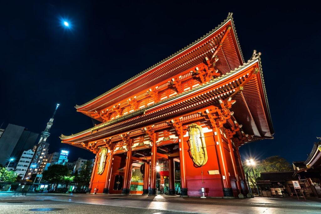 Image of the entrance gate of a temple in Tokyo, Japan, featuring traditional Japanese architecture and vibrant colors.