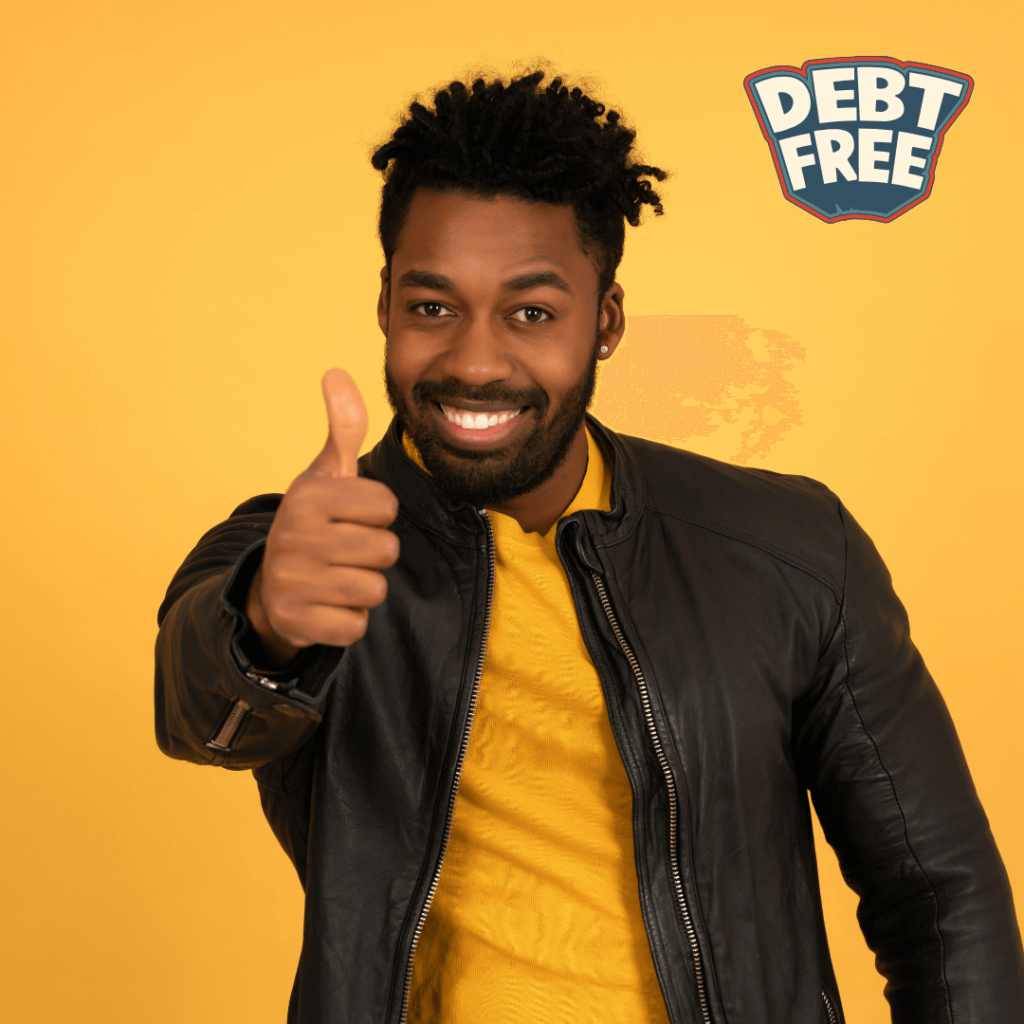 A person wearing a black leather jacket and a yellow shirt, giving a thumbs-up gesture, with 'DEBT FREE' written in bold white letters with a blue outline in the top right corner.