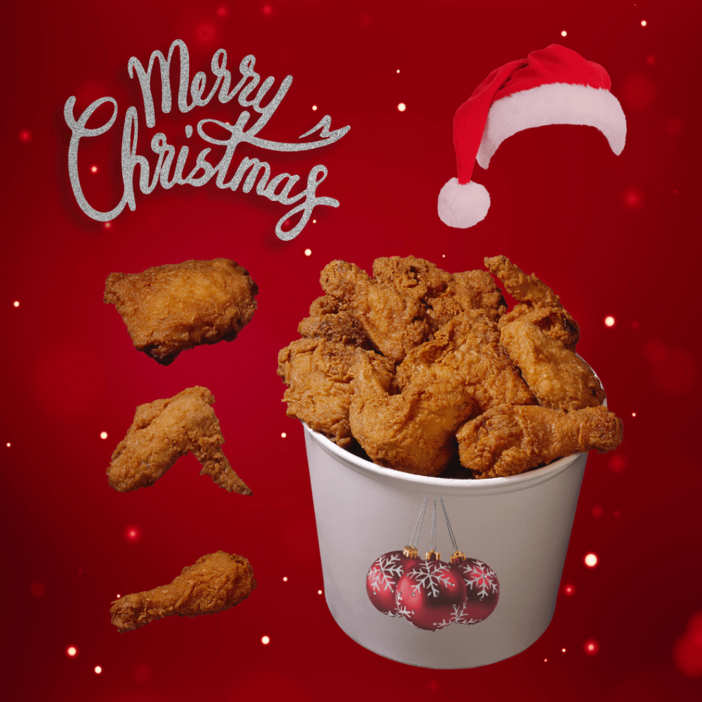 A festive Christmas-themed illustration featuring a bucket of fried chicken, adorned with Christmas ornaments and a Santa hat, with 'Merry Christmas' in glittery text